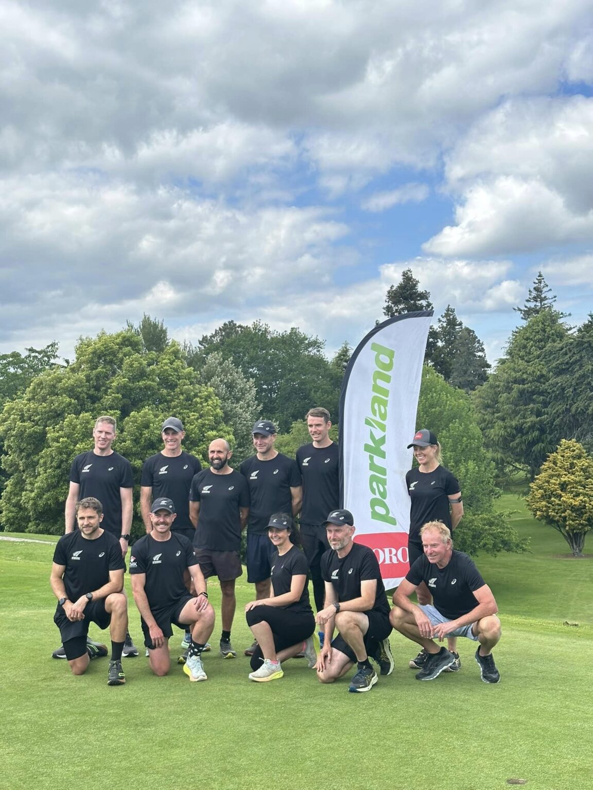 New Zealand speedgolf team posing for a photo by the Parkland Banner.