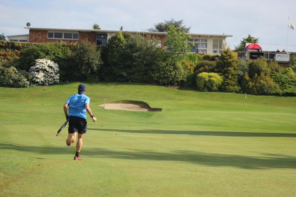 Man running while playing speedgolf