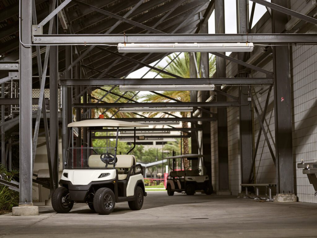 White Toro Vista Passenger Transport Vehicle parked under shelter 