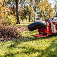 Ventrac Turbine Blower Attachment - blowing leaves in a public park