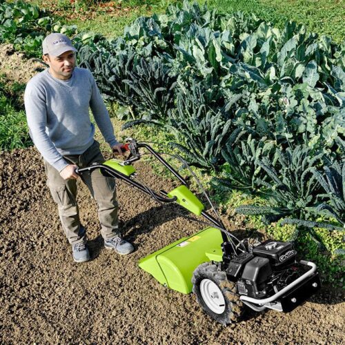 Tending to garden using a walking tractor