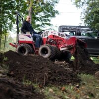 Ventrac Power Bucket 48" Tractor Attachment - collecting construction rubble