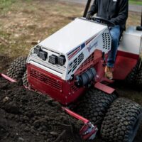 Ventrac Power Bucket 48" Tractor Attachment - collecting construction rubble