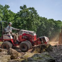 Ventrac 22" Stump Grinder Tractor Attachment - in use, grinding a stump