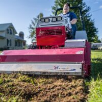 Ventrac Tiller Tractor Attachment - female driving through turf