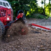 Ventrac Trencher Tractor Attachment - close up of blades as they work