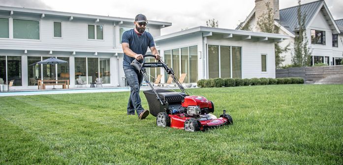 Self Propelled Walk Behind Mower in Backyard