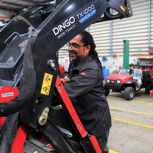 Service technician fixing a utility loader