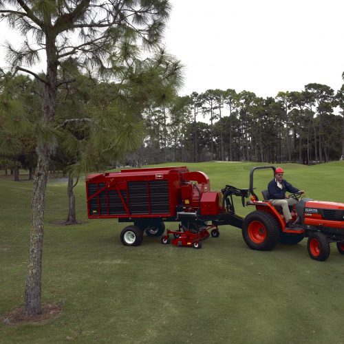 Sweeper clearing debris off golf course